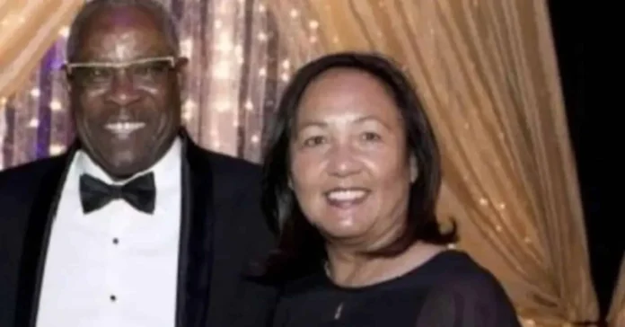 Melissa Esplana smiling at a formal event, standing beside a man in a tuxedo, with a golden curtain backdrop.