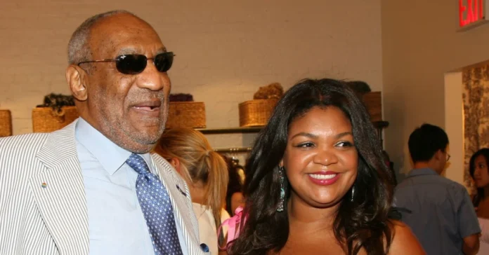 Evin Harrah Cosby attending a social event, standing beside a man in a light suit, with guests and woven baskets in the background.
