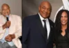 Adrienne Calhoun with George Foreman at a formal event, highlighting Adrienne Calhoun’s presence.