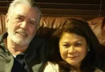 Nila Ermey sitting on a brown leather couch with her husband, sharing a quiet moment at home.