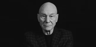 Patrick Stewart seated confidently in a stylish blazer, embodying his iconic presence as a legendary actor in film and television.