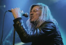 Wes Scantlin performing live on stage with microphone, Puddle of Mudd frontman whose net worth reached $500K in 2025