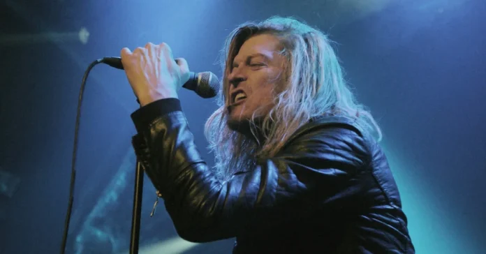 Wes Scantlin performing live on stage with microphone, Puddle of Mudd frontman whose net worth reached $500K in 2025