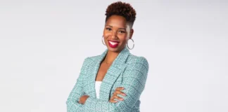 Portrait of Monica McNutt, basketball analyst and media personality, confidently presenting insights on sports with a professional backdrop.