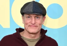 Woody Harrelson at premiere event wearing signature flat cap and burgundy hoodie, embodying the casual wellness-focused lifestyle of the Hollywood actor