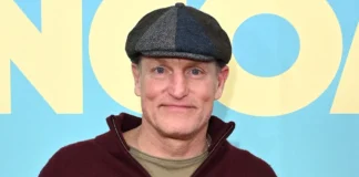 Woody Harrelson at premiere event wearing signature flat cap and burgundy hoodie, embodying the casual wellness-focused lifestyle of the Hollywood actor